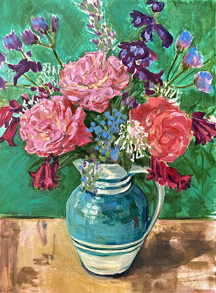 A portrait format figurative oil painting by Nina Packer of a jug of Summer flowers against an emerald green background. The flowers are loosely painted: three pink roses, with dark red bell like flowers and blue and purple blooms, all picked from the garden, the jug is teal green and cream stripe, set on a pale brown/gold table top.
